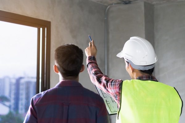 Client and Contractor discussing plan to renovation house.